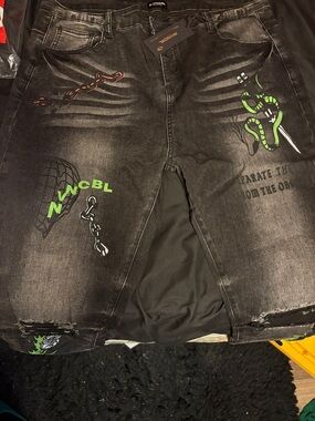 Black Distressed Graphic Jeans with Neon Green Snake Accents